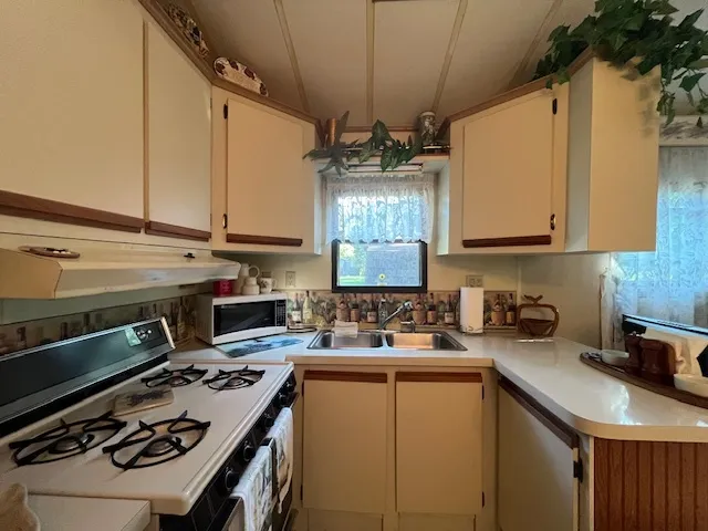 a kitchen with stainless steel appliances kitchen island granite countertop a stove and a refrigerator