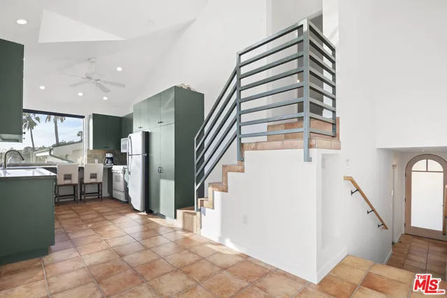 a view of a kitchen with furniture and staircase