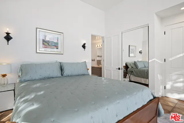 a large bedroom with a large bed and couch