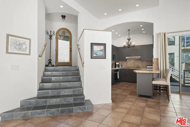 a view of kitchen with sink and refrigerator