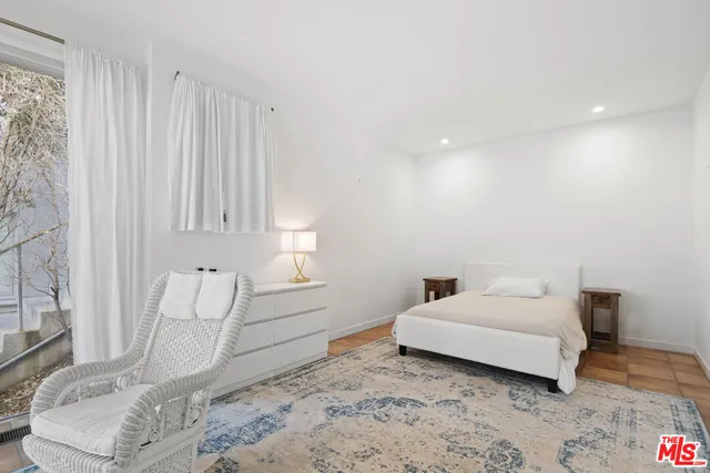 a spacious bedroom with a bed and a couch