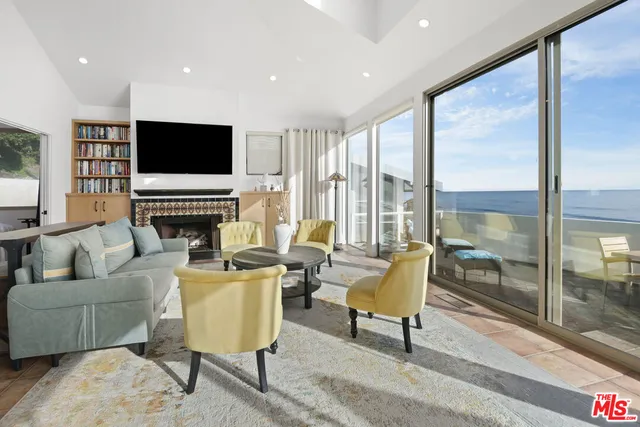 a living room with furniture floor and a flat screen tv