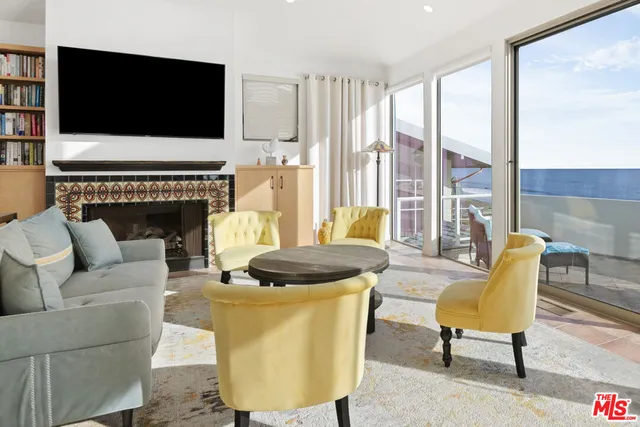 a living room with furniture fireplace and flat screen tv