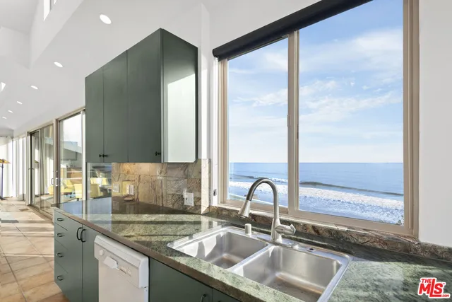a kitchen with a sink and a large window