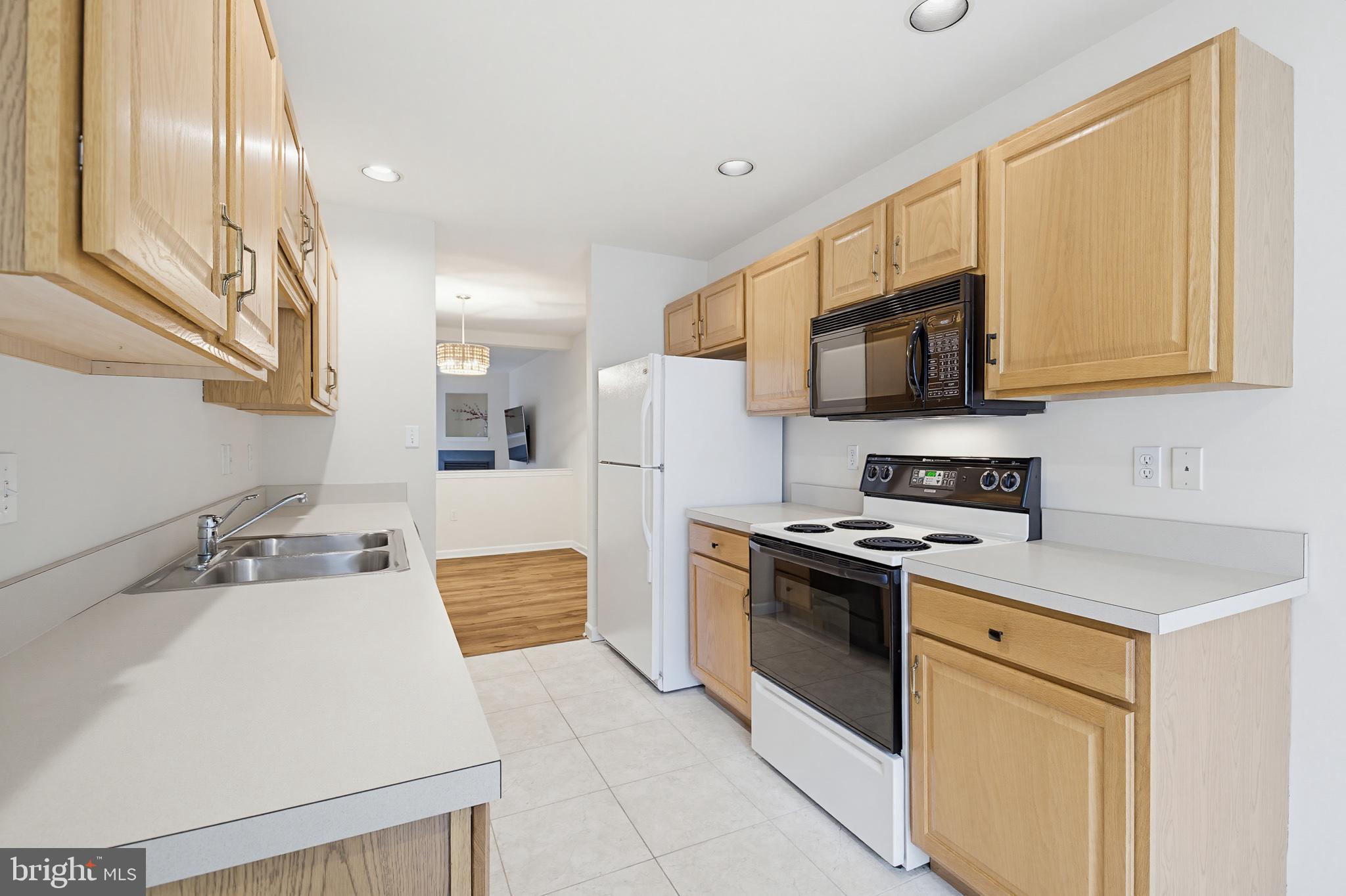 1037 Kent Garden Lititz, PA 17543 - Photo 18 of 31 a kitchen with stainless steel appliances a stove a sink a microwave and cabinets