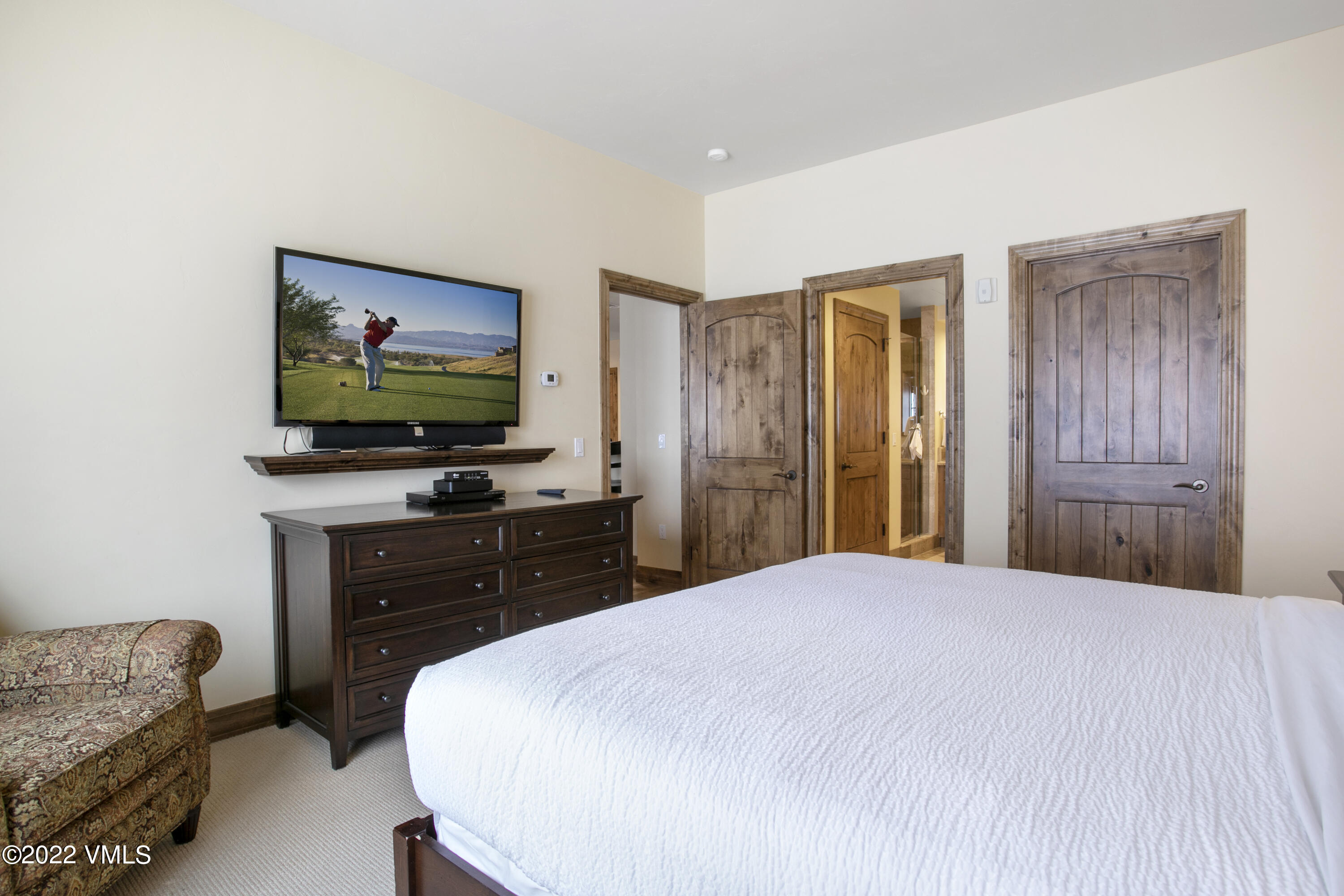 300 Prater Road, Unit B303 Beaver Creek, CO 81620 - Photo 13 of 38 a bedroom with a bed and a flat screen tv