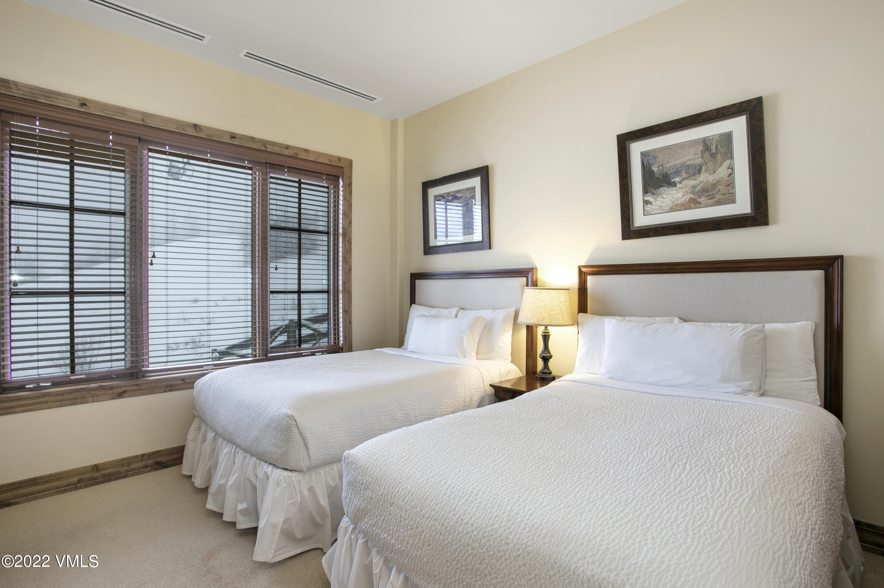 300 Prater Road, Unit B303 Beaver Creek, CO 81620 - Photo 16 of 38 a bedroom with two beds and a large window
