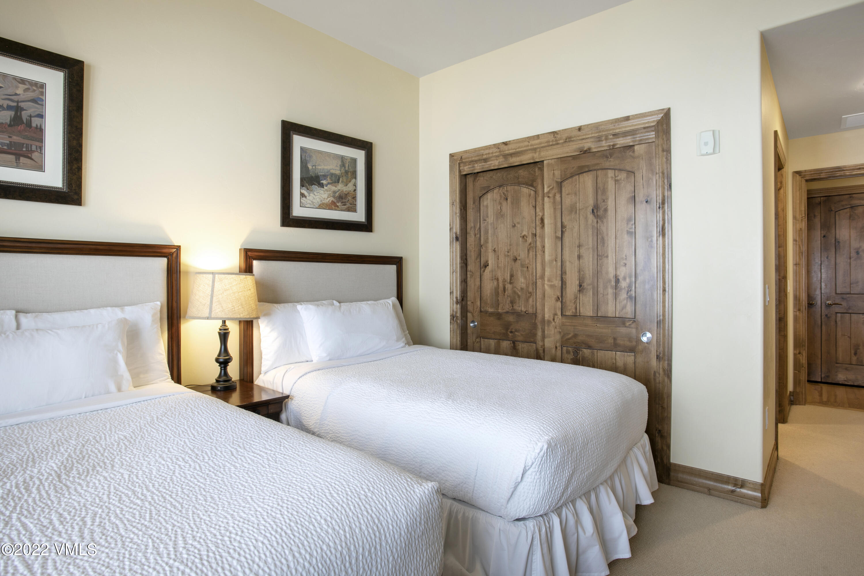 300 Prater Road, Unit B303 Beaver Creek, CO 81620 - Photo 18 of 38 a bedroom with two beds and a lamp