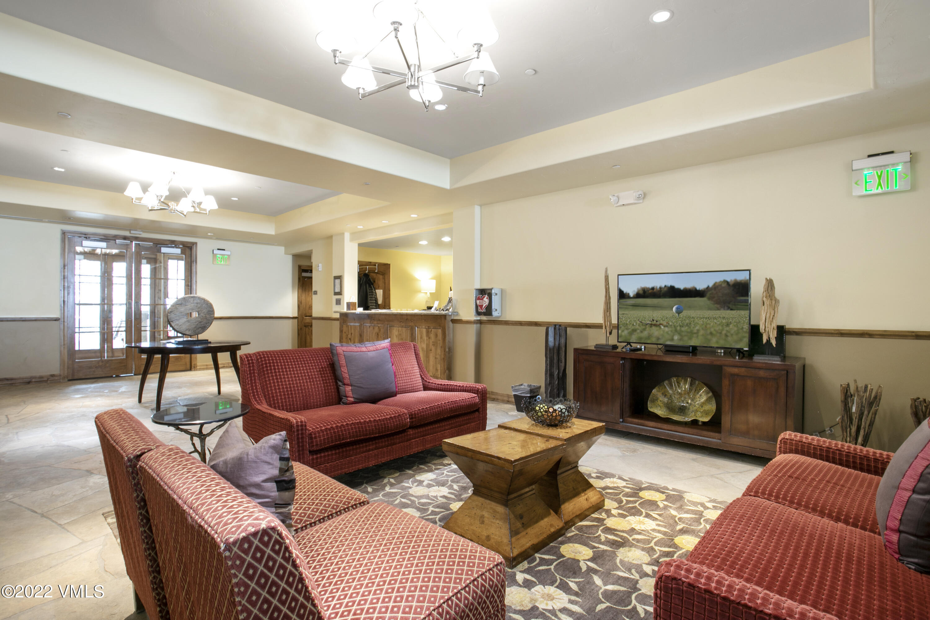 300 Prater Road, Unit B303 Beaver Creek, CO 81620 - Photo 26 of 38 a living room with furniture a fireplace and a flat screen tv