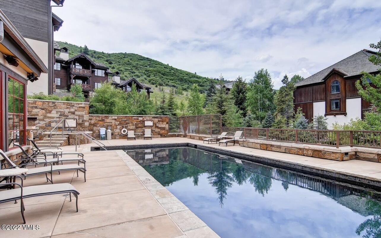 300 Prater Road, Unit B303 Beaver Creek, CO 81620 - Photo 37 of 38 a swimming pool with outdoor seating and city view