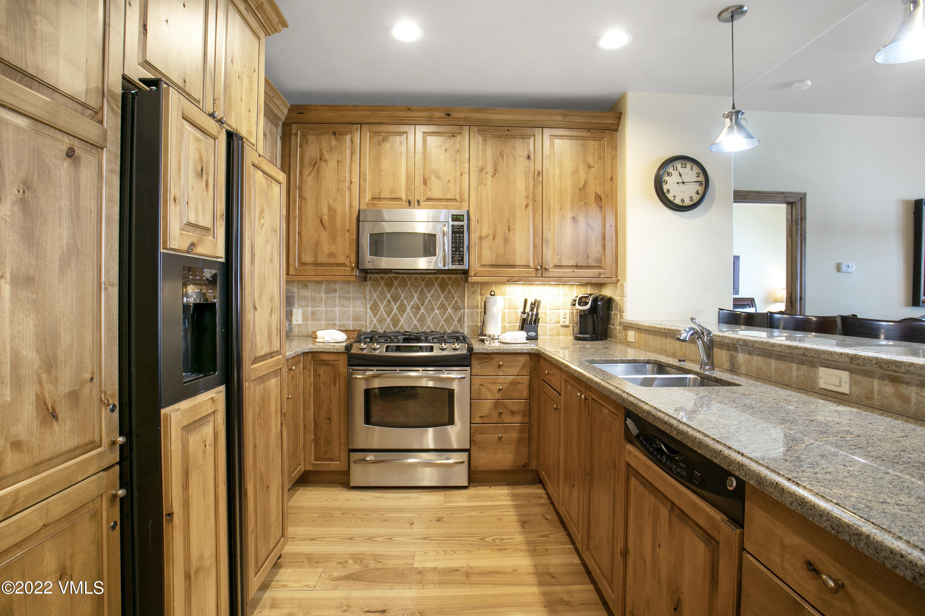 300 Prater Road, Unit B303 Beaver Creek, CO 81620 - Photo 8 of 38 a kitchen with a sink cabinets stainless steel appliances and a window