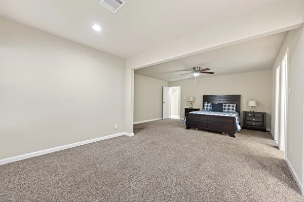 a bedroom with a bed and a ceiling fan