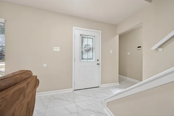 a front view of a house with white wall