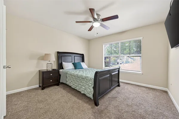 a living room with a bed furniture and a window