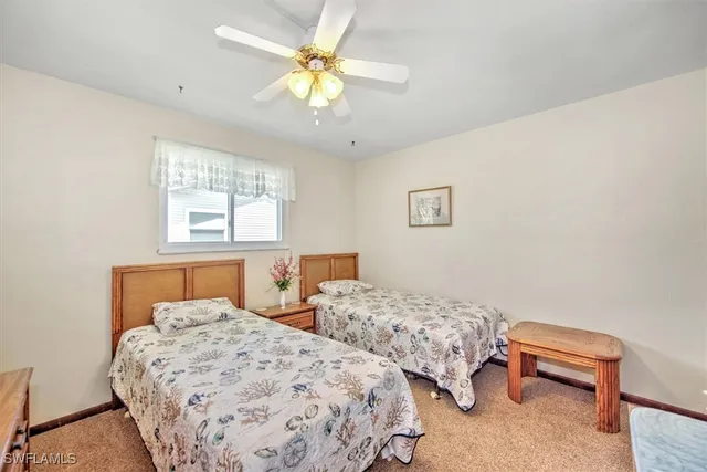 a bedroom with two beds and a chandelier