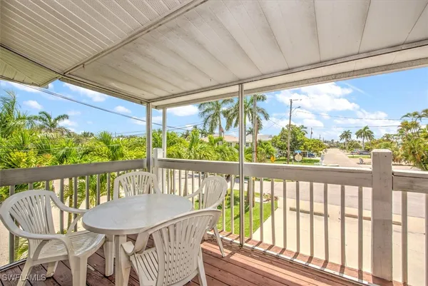 a view of a balcony with wooden floor