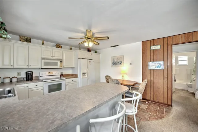a kitchen with a table and chairs in it