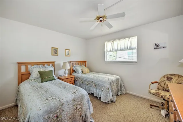 a bedroom with two beds and a chandelier