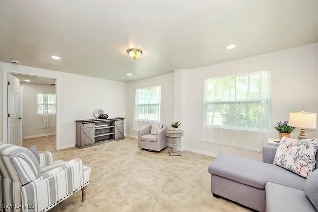 a living room with furniture and a large window