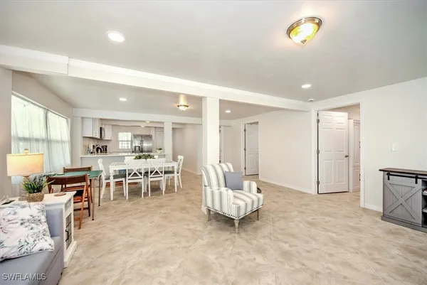a living room with furniture a dining table and a stove top oven