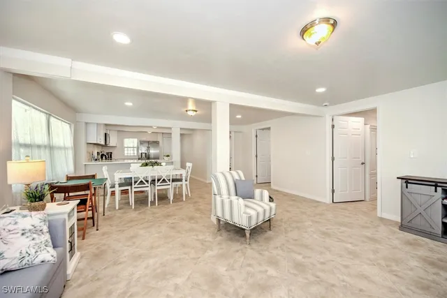 a living room with furniture a dining table and a stove top oven