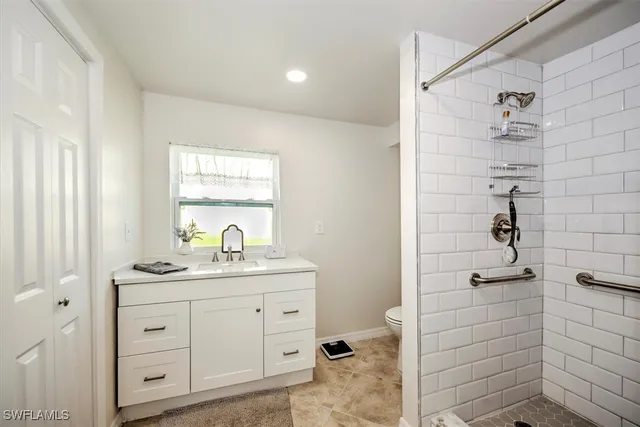 a bathroom with a shower a sink and a mirror