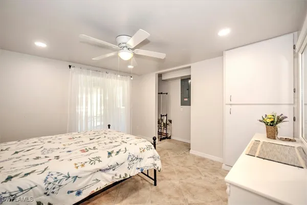 a spacious bedroom with a bed and a dresser with rug