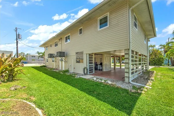a view of a house with a backyard porch and sitting area