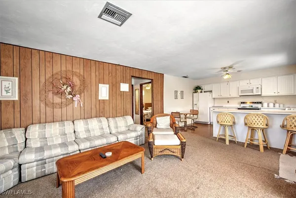 a living room with furniture a table and chairs