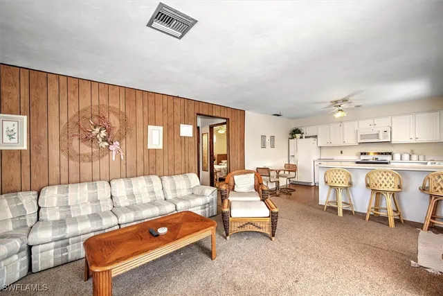 a living room with furniture a table and chairs