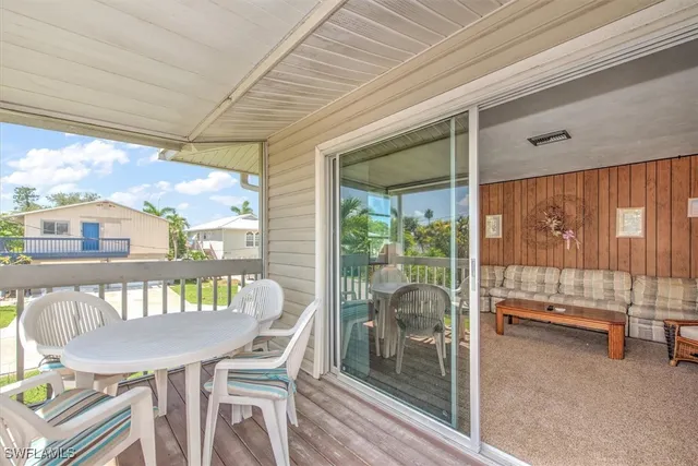 a dining room with furniture and a floor to ceiling window