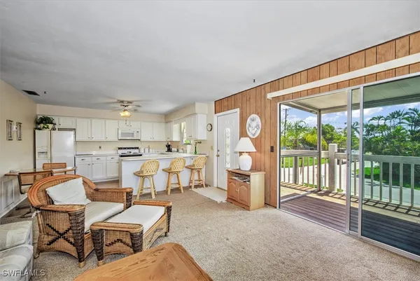 a living room with lots of furniture and a large window