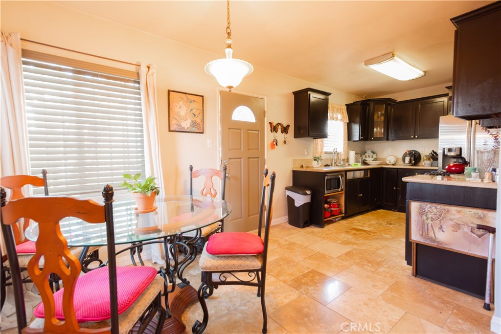 1500 West 156th Street Compton, CA 90220 - Photo 16 of 32 a kitchen with stainless steel appliances kitchen island granite countertop a sink and cabinets