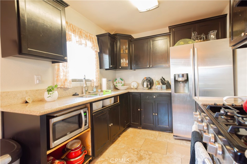 1500 West 156th Street Compton, CA 90220 - Photo 20 of 32 a kitchen with a sink appliances and cabinets