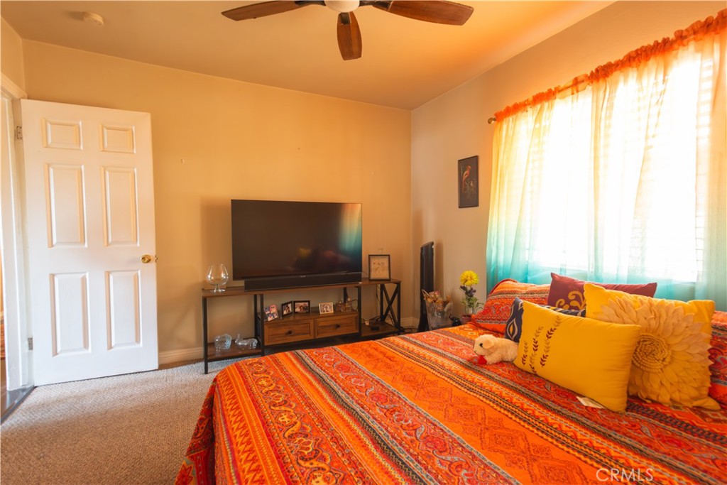 1500 West 156th Street Compton, CA 90220 - Photo 23 of 32 a bedroom with a bed and a flat screen tv