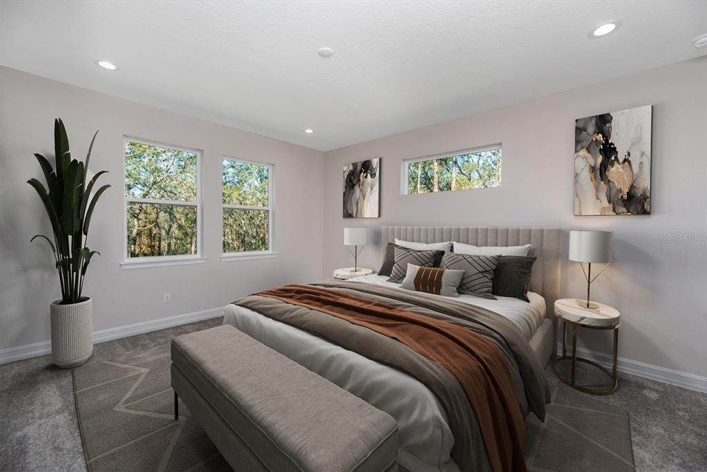 10512 Southwest 49th Ave Road Ocala, FL 34476 - Photo 12 of 13 a bedroom with a bed and a potted plant