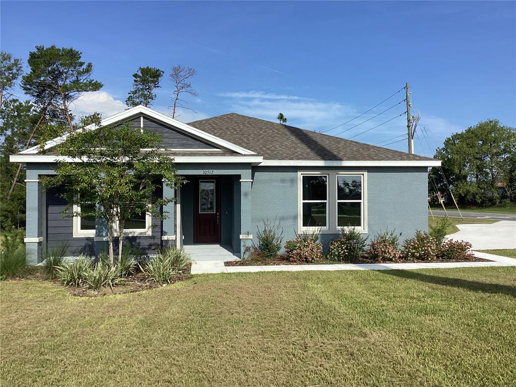 10512 Southwest 49th Ave Road Ocala, FL 34476 - Photo 2 of 13 a front view of a house with garden