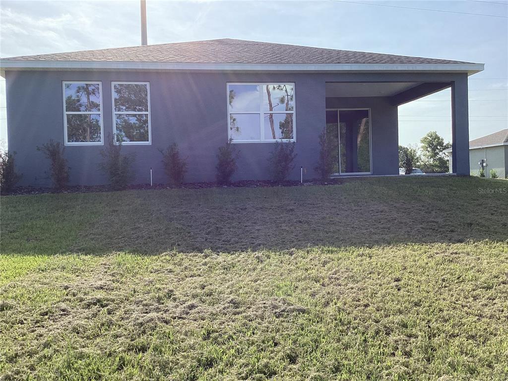 10512 Southwest 49th Ave Road Ocala, FL 34476 - Photo 6 of 13 a view of a house with a yard