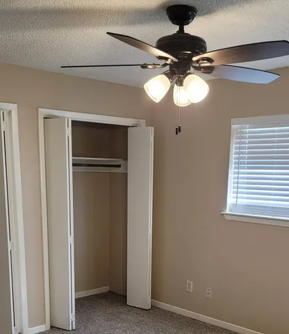 a view of a chandelier fan and a window