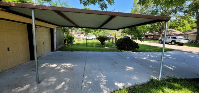 a view of a patio with table and chairs under an umbrella