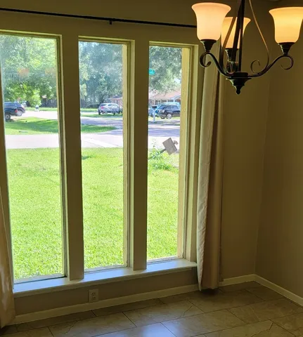 a view of a room that has a bed and a window