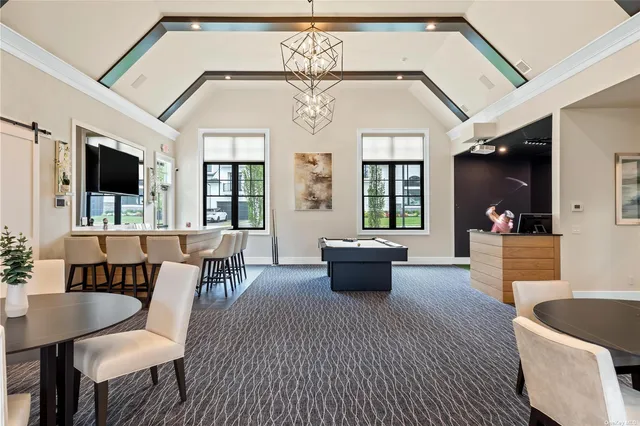 a living room with furniture a table and chairs