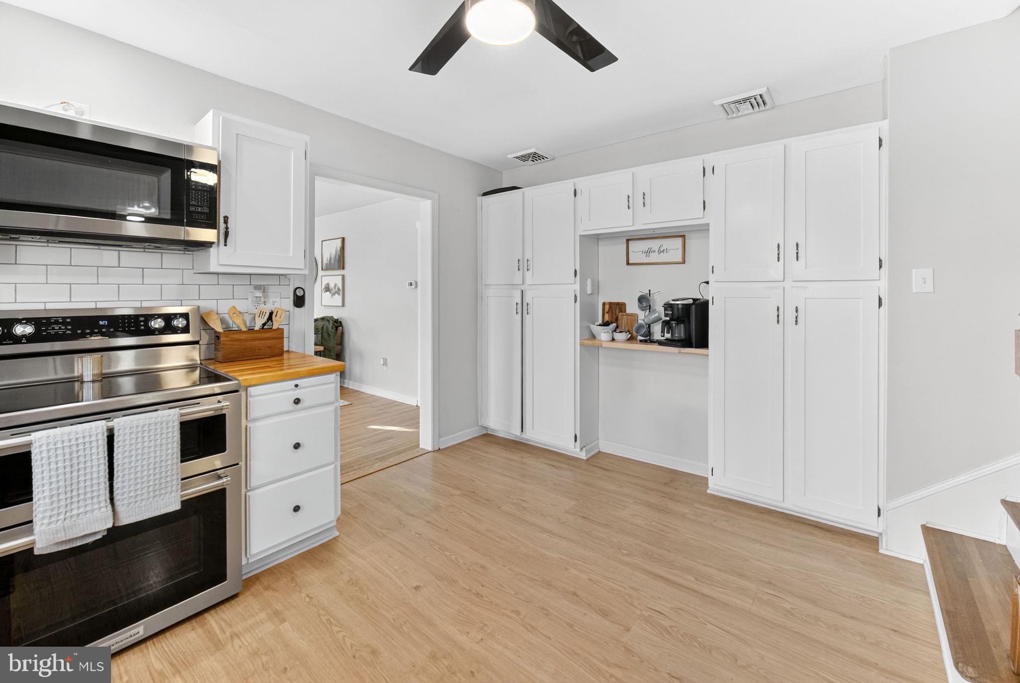 616 Bondsville Road Downingtown, PA 19335 - Photo 20 of 43 a kitchen with stainless steel appliances white cabinets and a refrigerator