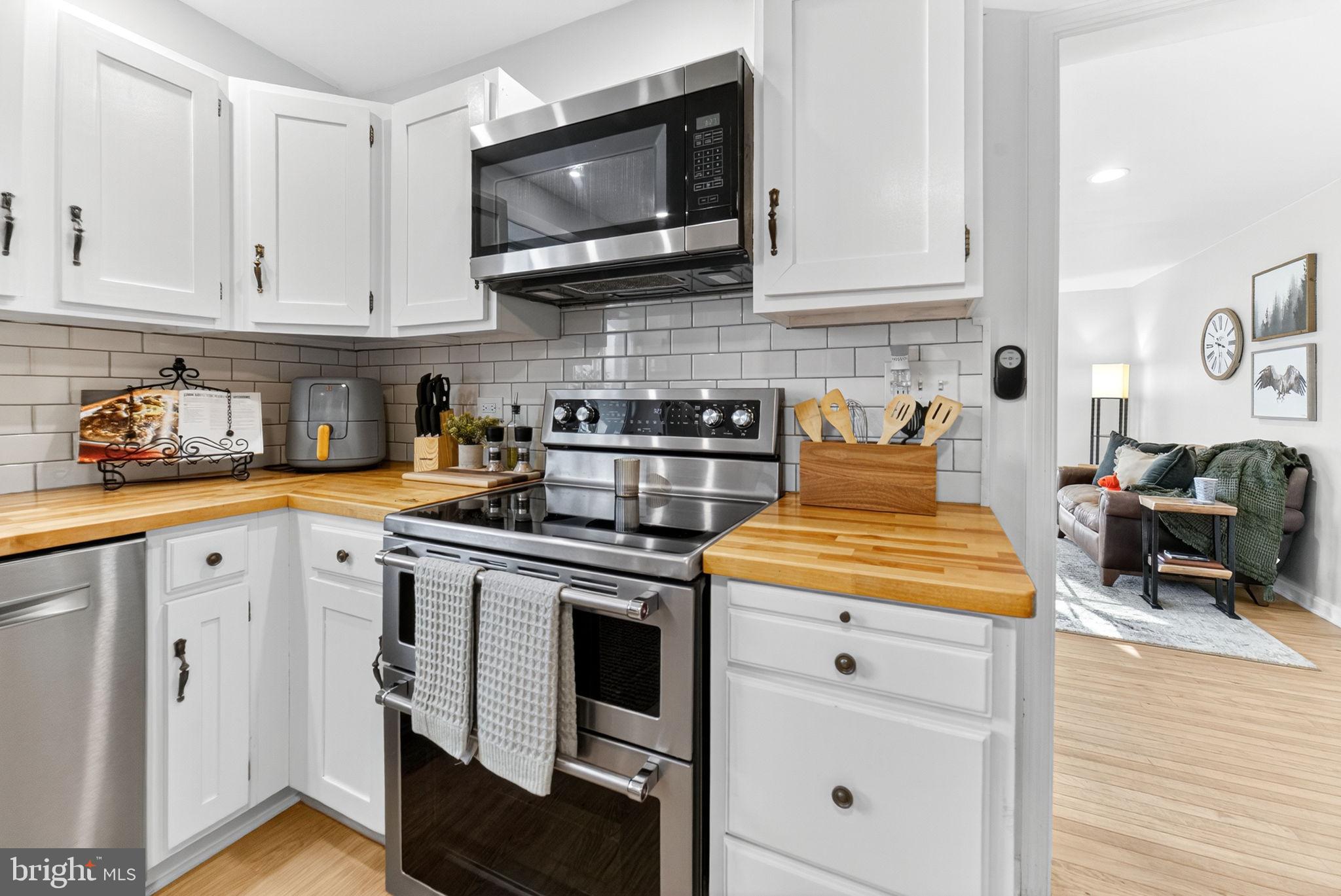 616 Bondsville Road Downingtown, PA 19335 - Photo 21 of 43 a kitchen with stainless steel appliances granite countertop a stove a microwave and cabinets
