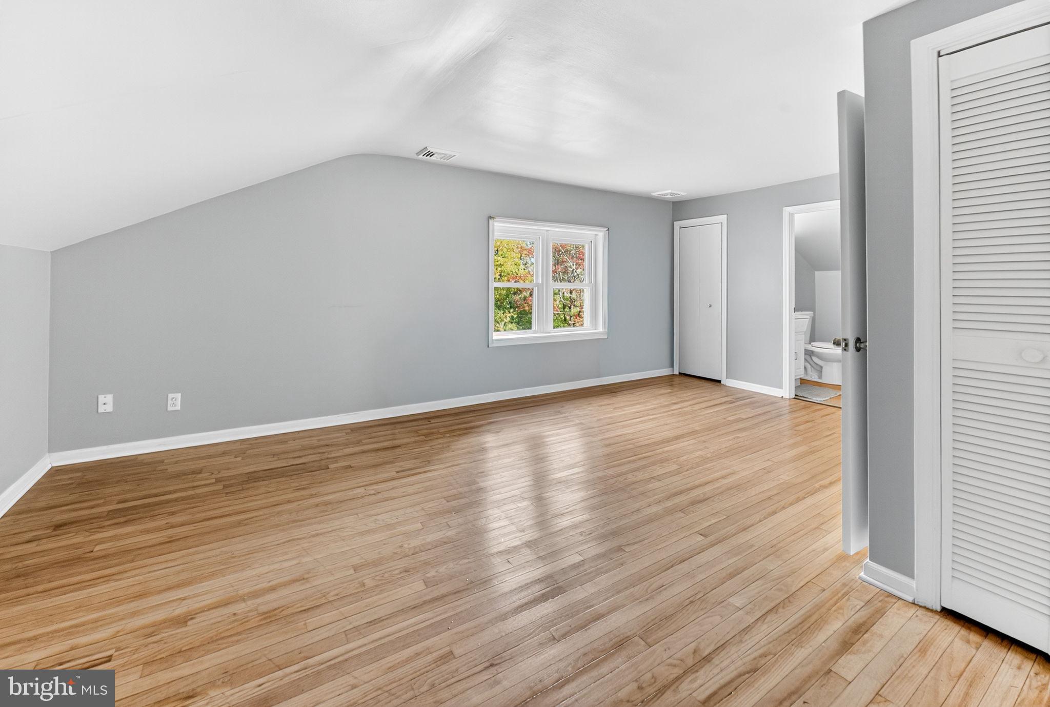 616 Bondsville Road Downingtown, PA 19335 - Photo 24 of 43 an empty room with wooden floor and windows