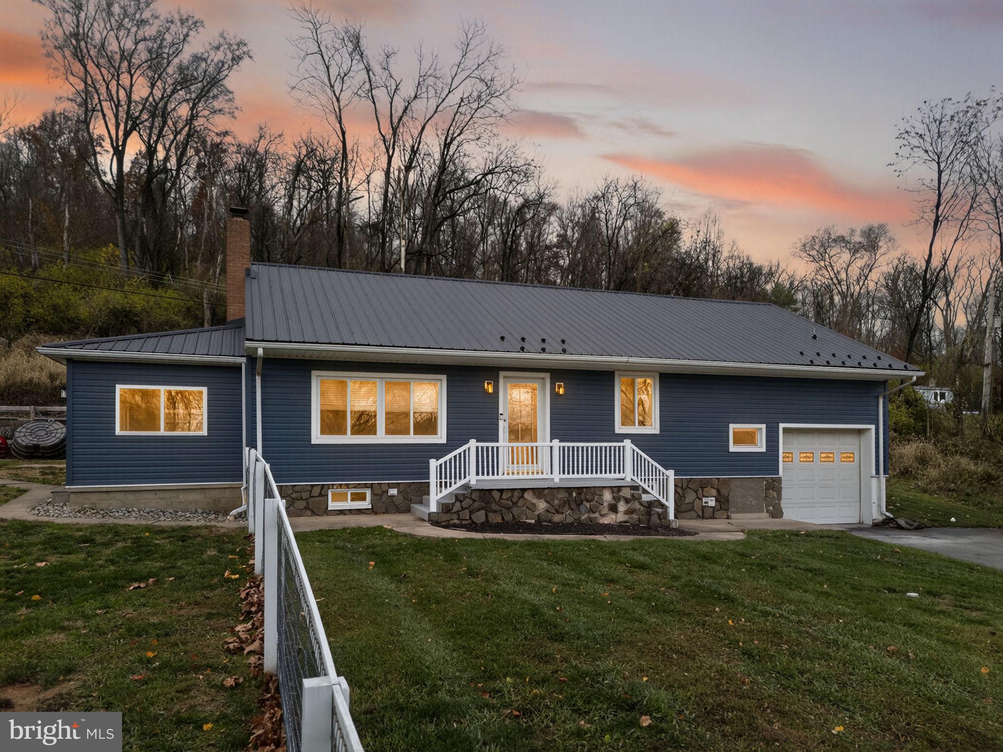 616 Bondsville Road Downingtown, PA 19335 - Photo 43 of 43 a front view of a house with a yard table and chairs