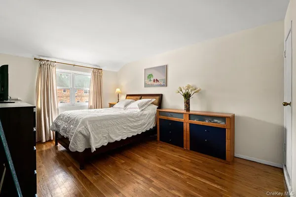 a bedroom with a bed and dresser