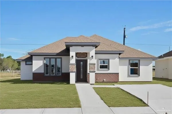 a front view of a house with a yard