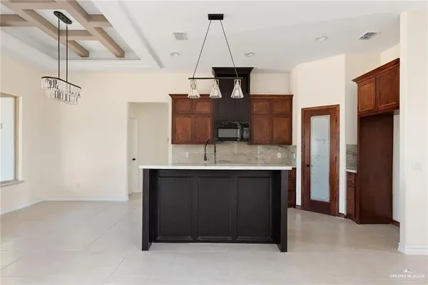 a kitchen with stainless steel appliances granite countertop a sink and a refrigerator