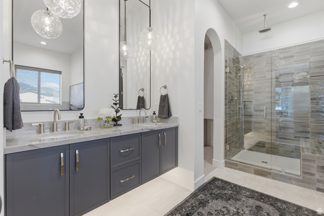 2559 West Aurora Avenue Mapleton, UT 84664 - Photo 17 of 60 Dual vanity with stone countertop and undermount sinks, featuring individual rectangular mirrors and decorative pendant lighting